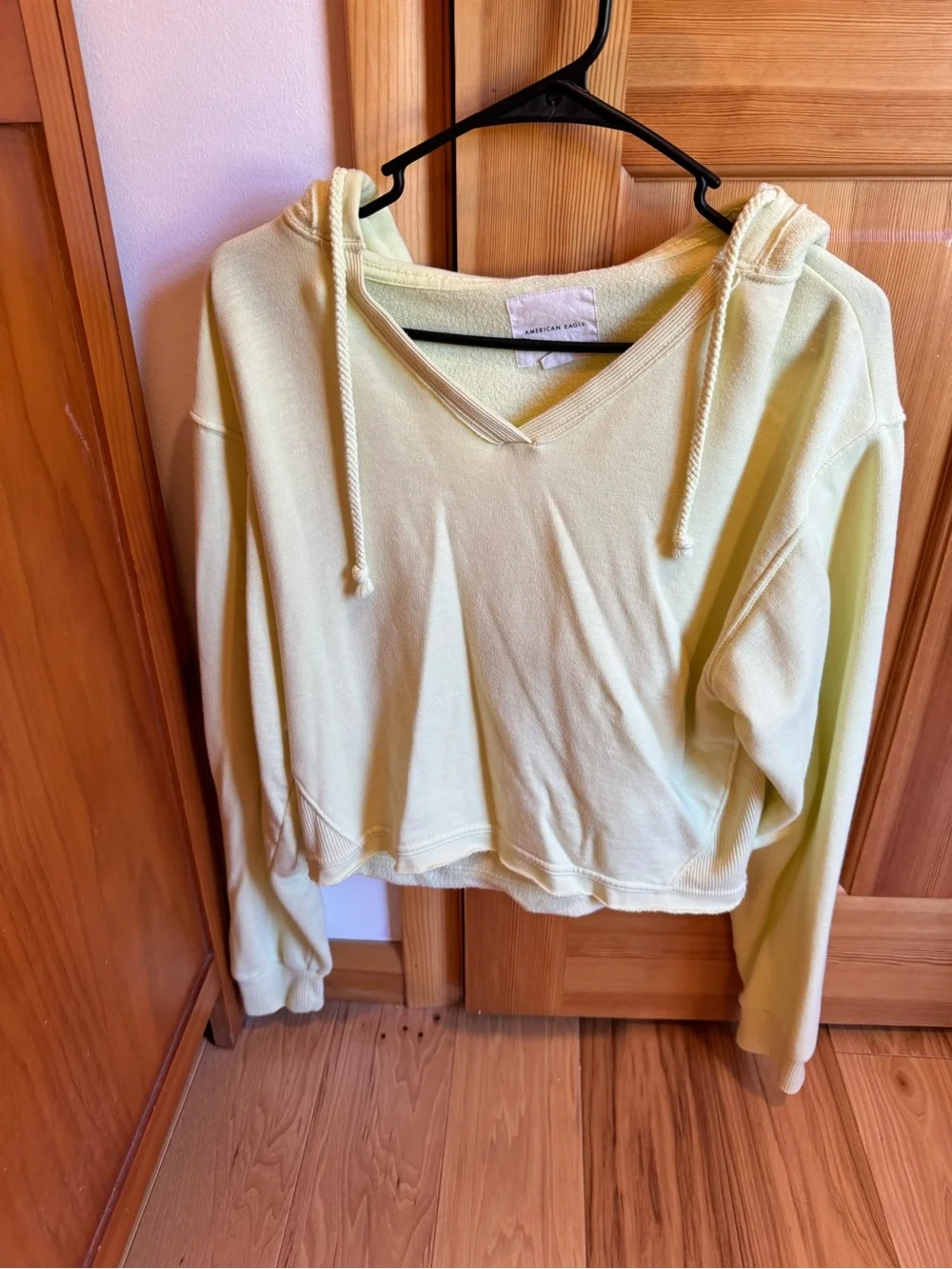 American Eagle Outfitters V-Neck Cropped Hoodie in Pale Yellow